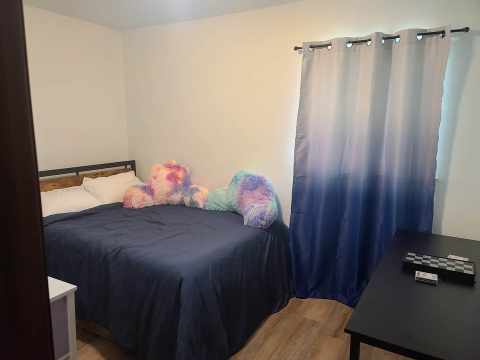 Fantasy room with a double bed, plush toys, and ombre curtains