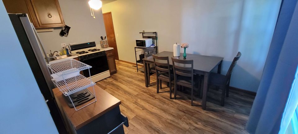 Full kitchen with stainless refrigerator and a dining table for six